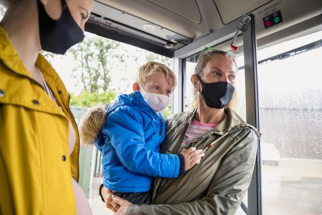 Mother and child in masks on bus