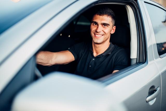 Happy male driving a car